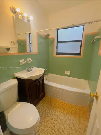 a bathroom with a sink a toilet and bathtub