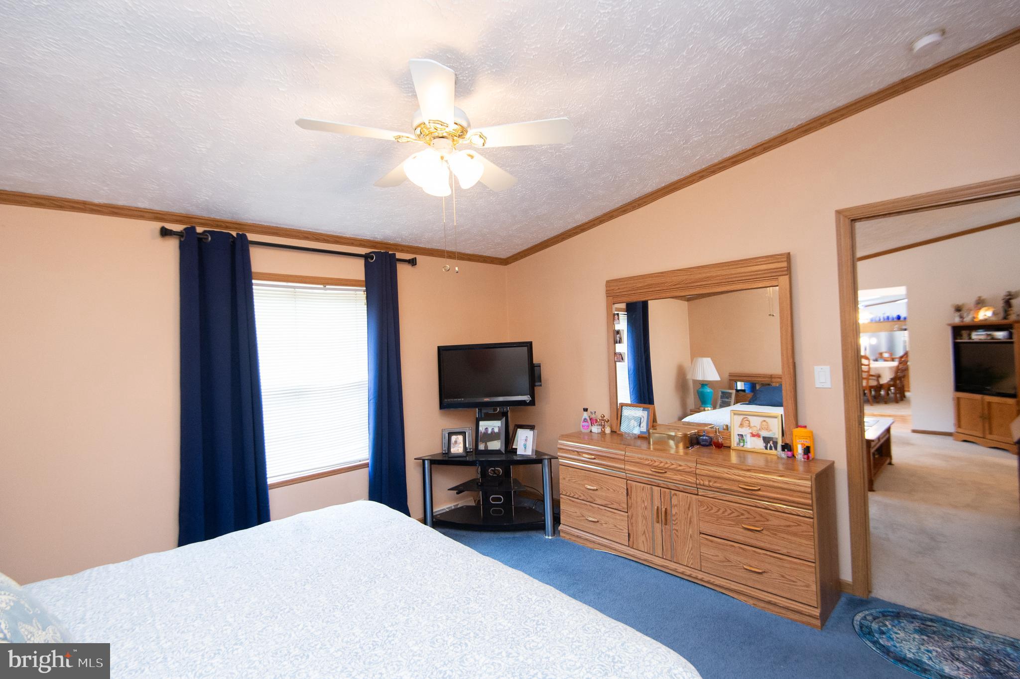 5622 Ross Neck Road Cambridge, MD 21613 - Photo 21 of 42 a bedroom with a bed and a chandelier