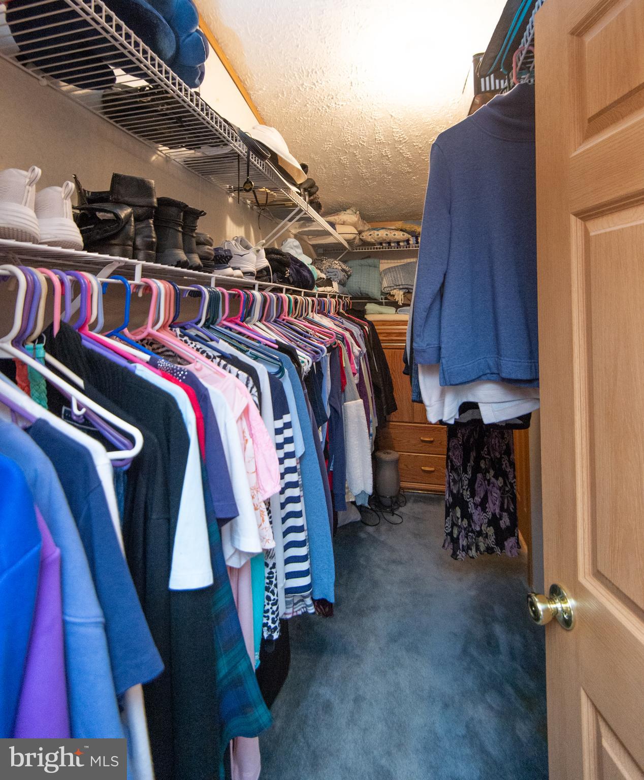 5622 Ross Neck Road Cambridge, MD 21613 - Photo 24 of 42 a view of walk in closet with clothes and shoes