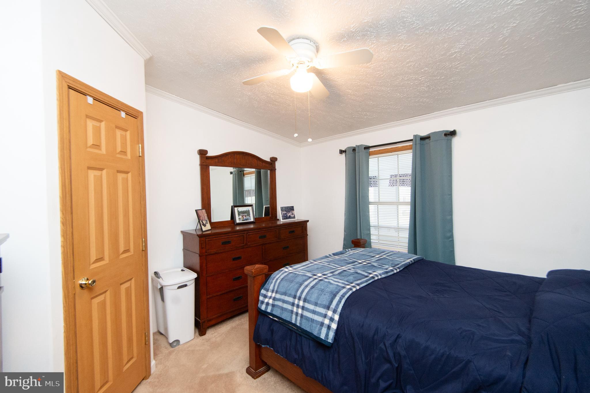 5622 Ross Neck Road Cambridge, MD 21613 - Photo 25 of 42 a bedroom with a bed and a dresser next to a window