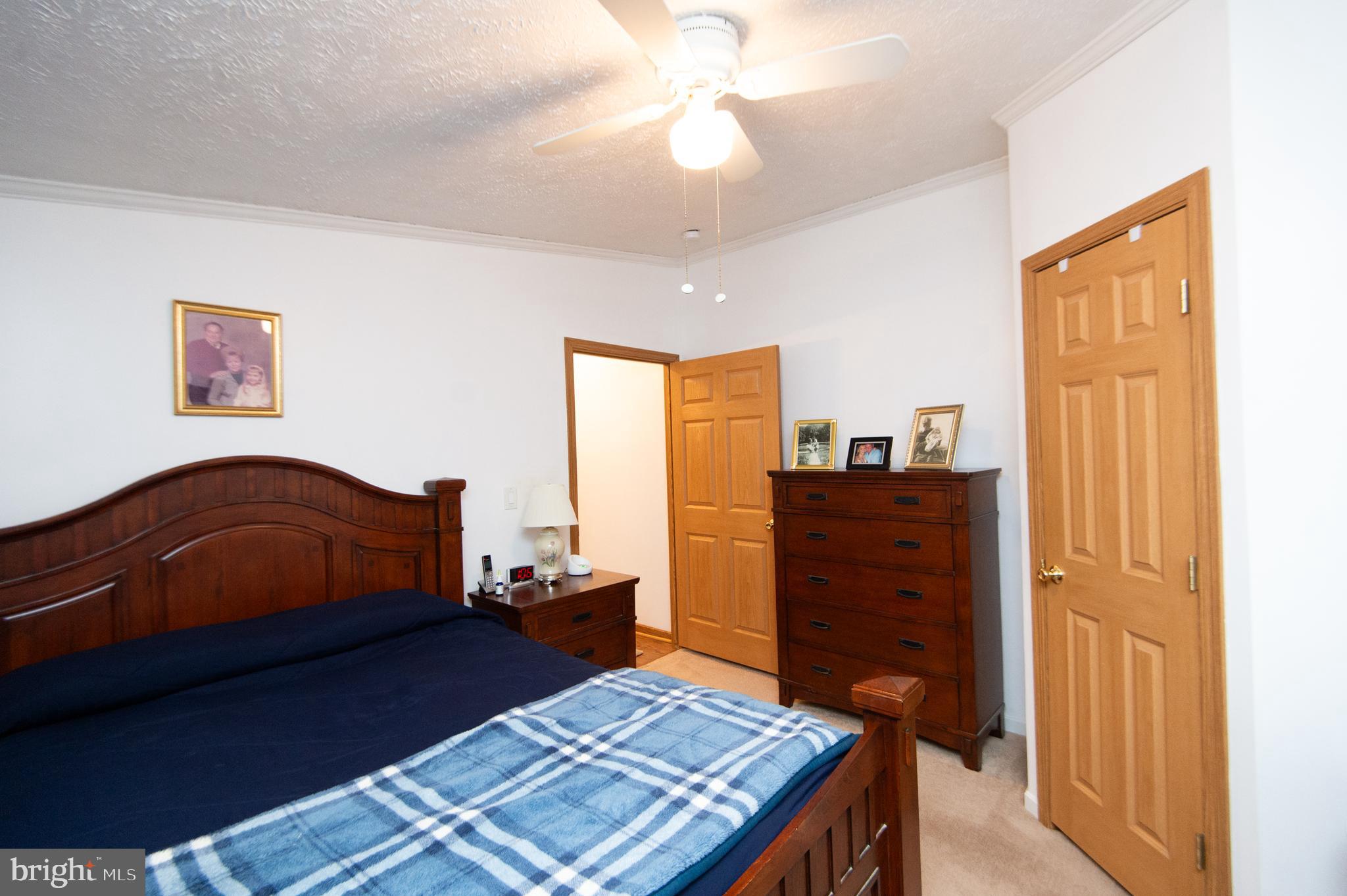 5622 Ross Neck Road Cambridge, MD 21613 - Photo 26 of 42 a bedroom with a bed and wooden floor