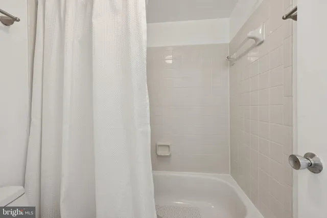 a bathroom with a shower and a bath tub