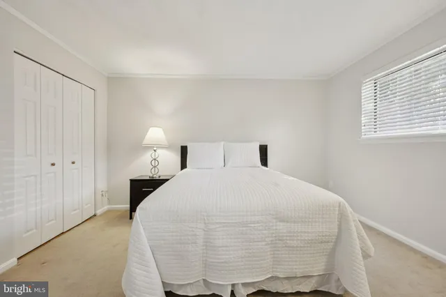 a bedroom with a bed and a night stand