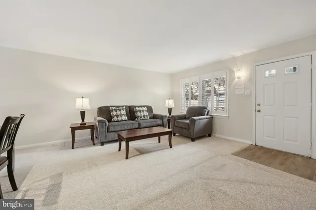 a living room with furniture and a lamp