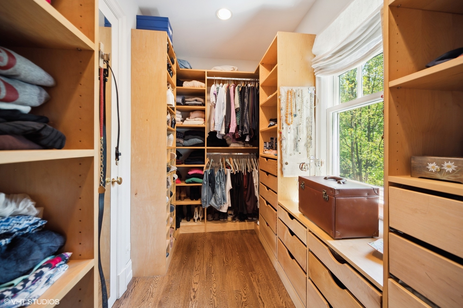 1024 Westmoor Road Winnetka, IL 60093 - Photo 19 of 38 a view of a walk in closet with clothes and shoes