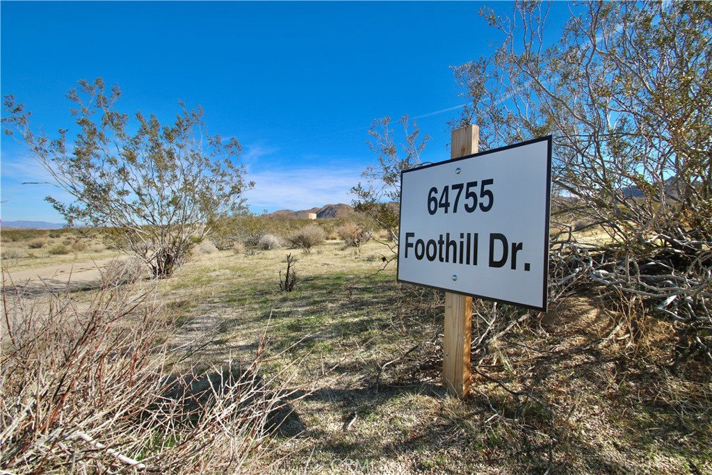 64755 Foothill Drive Joshua Tree, CA 92252 - Photo 1 of 12 a sign that is on the side of a building