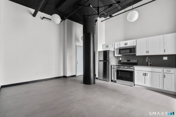 a view of a kitchen with electric appliances