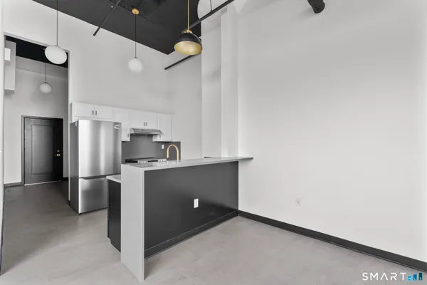 a kitchen with stainless steel appliances a refrigerator and a stove