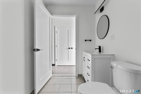 a bathroom with a toilet sink and a mirror