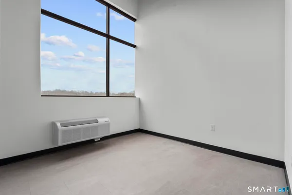 a view of a room with air conditioner and a window