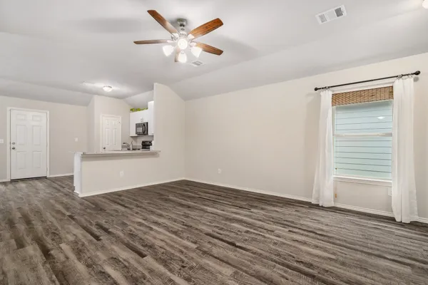 wooden floor in an empty room with a window