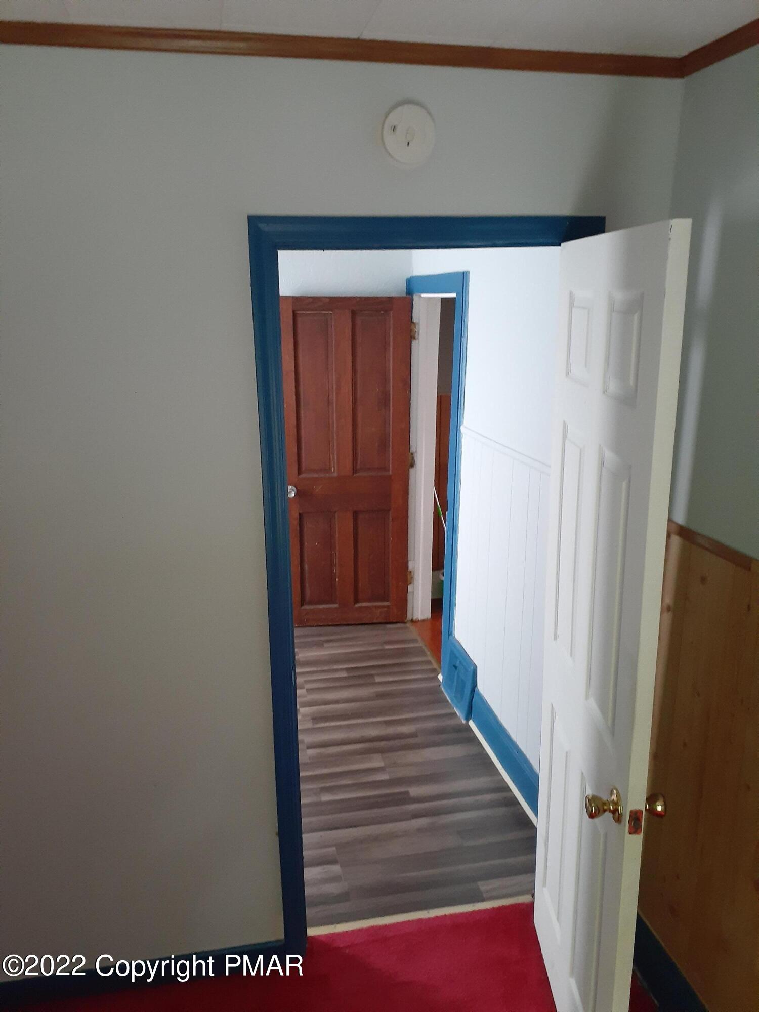 218 Ferdinand Street Scranton, PA 18508 - Photo 11 of 11 a view of a hallway with wooden floor and staircase