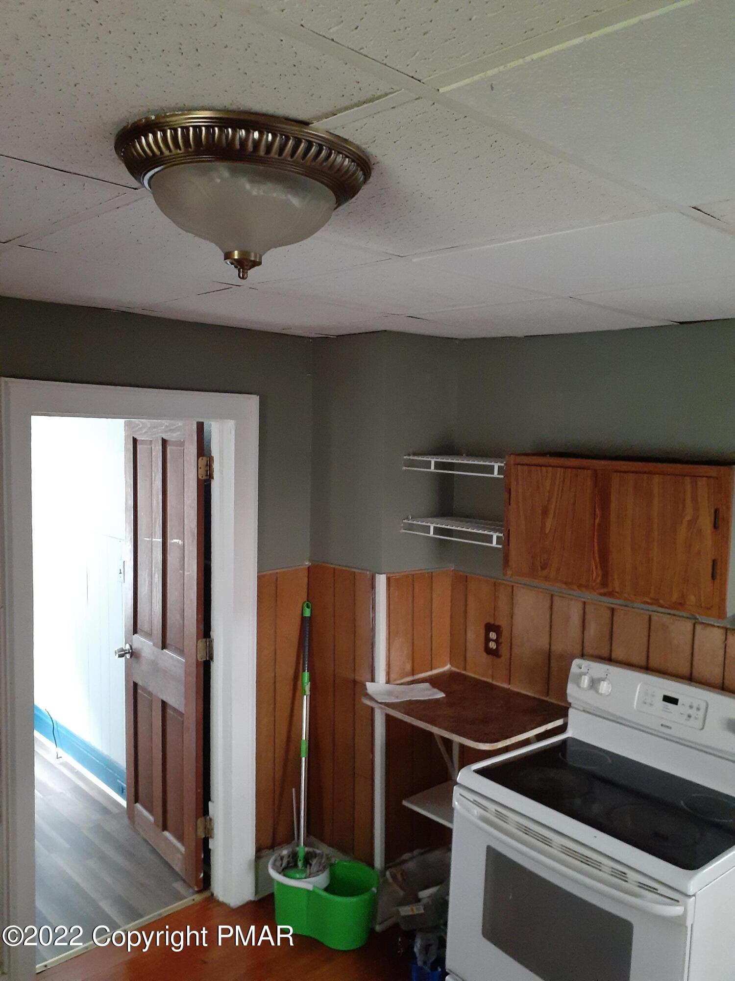 218 Ferdinand Street Scranton, PA 18508 - Photo 5 of 11 a kitchen with a stove and a refrigerator