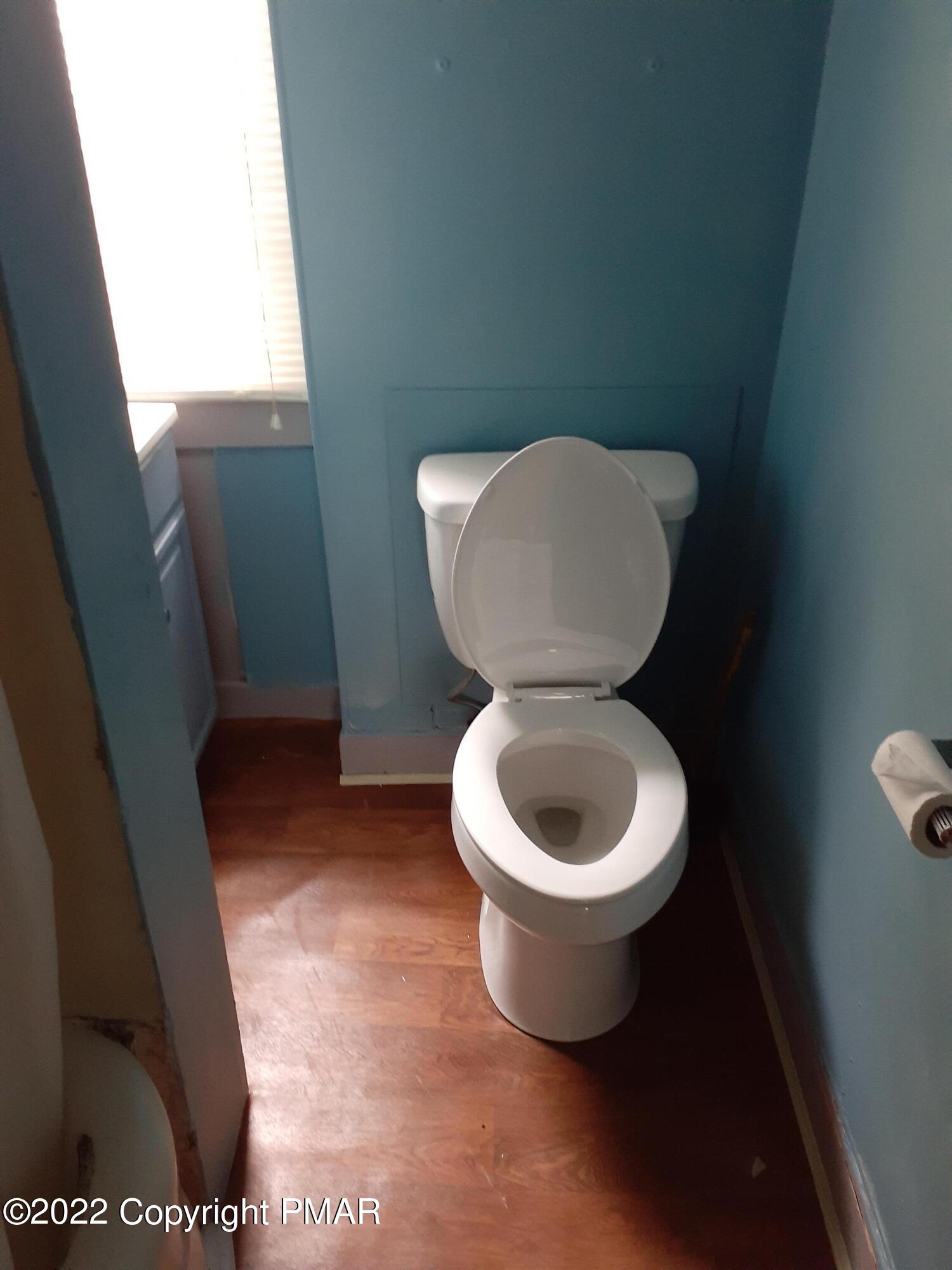 218 Ferdinand Street Scranton, PA 18508 - Photo 8 of 11 a white toilet sitting in a bathroom next to a sink