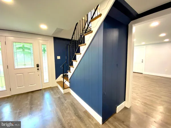 a view of entryway and hall with wooden floor