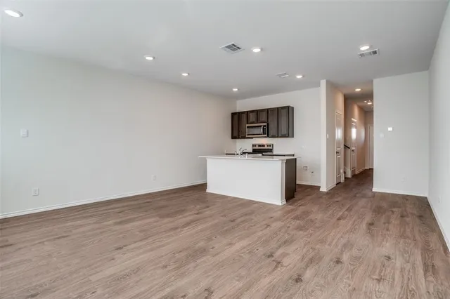 a bathroom with a granite countertop sink a toilet and a mirror