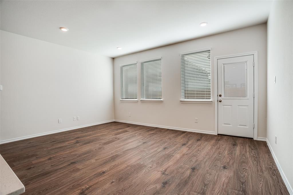321 Tall Cedar Way Princeton, TX 75407 - Photo 5 of 14 an empty room with wooden floor and window