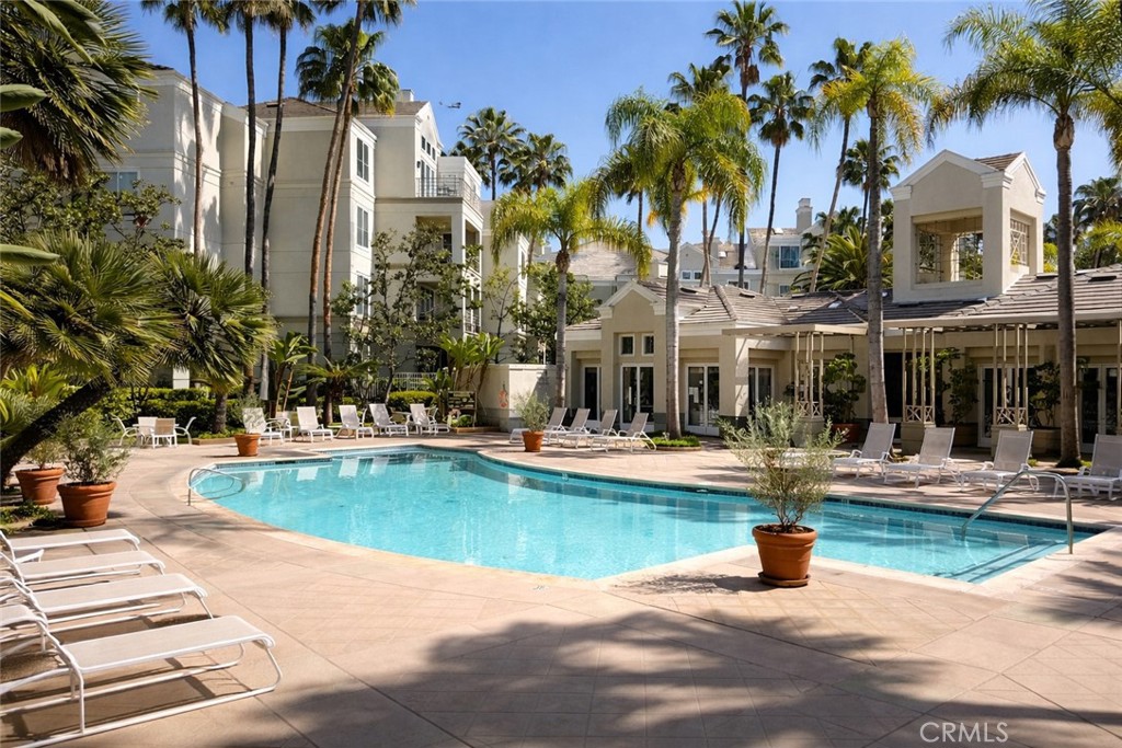 2253 Martin, Unit 107 Irvine, CA 92612 - Photo 12 of 17 a view of a swimming pool with a bench and palm trees