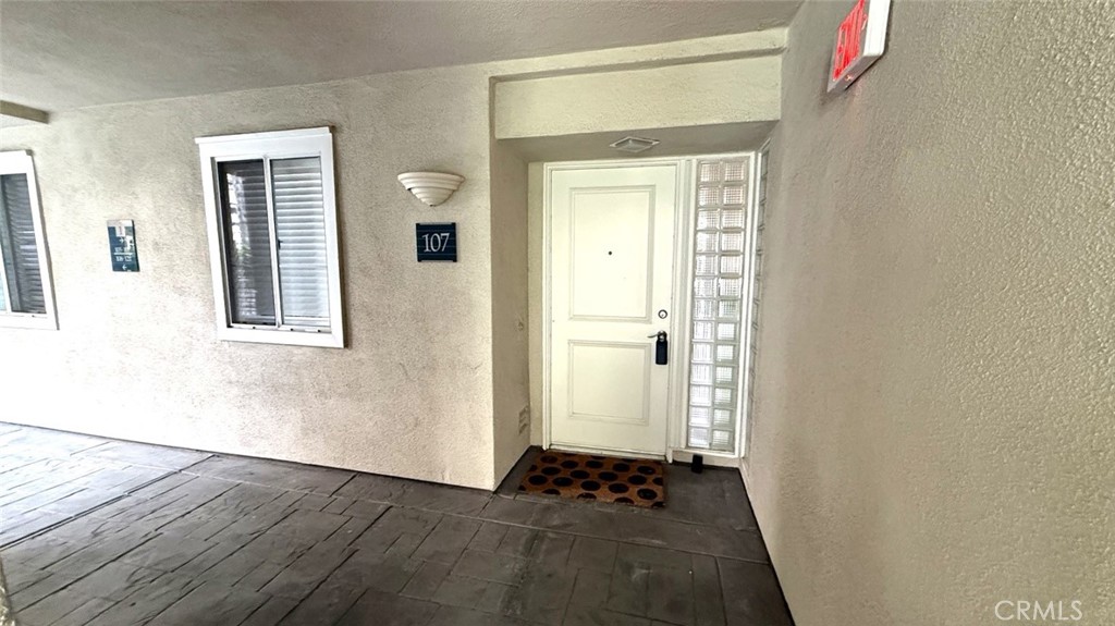 2253 Martin, Unit 107 Irvine, CA 92612 - Photo 2 of 17 a view of an empty room with wooden floor and a window