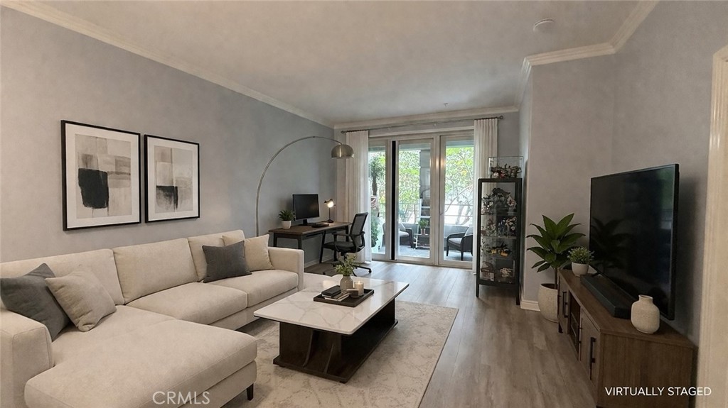 2253 Martin, Unit 107 Irvine, CA 92612 - Photo 4 of 17 a living room with furniture a flat screen tv and a floor to ceiling window