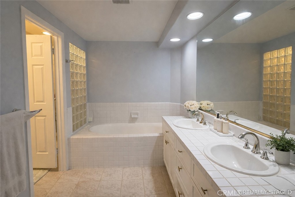 2253 Martin, Unit 107 Irvine, CA 92612 - Photo 7 of 17 a bathroom with a tub sink and mirror
