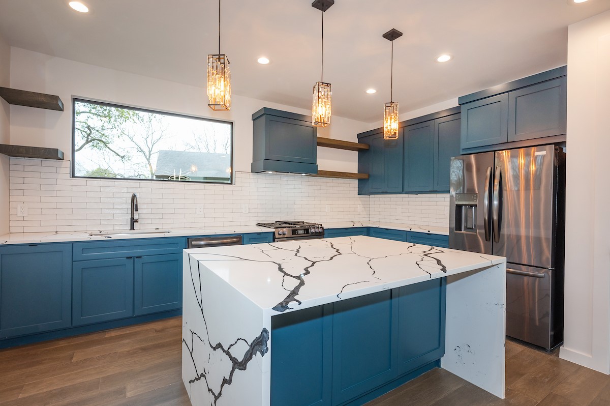 4906 Aberdeen Circle Austin, TX 78745 - Photo 11 of 28 a kitchen with stainless steel appliances granite countertop a sink a refrigerator and a microwave