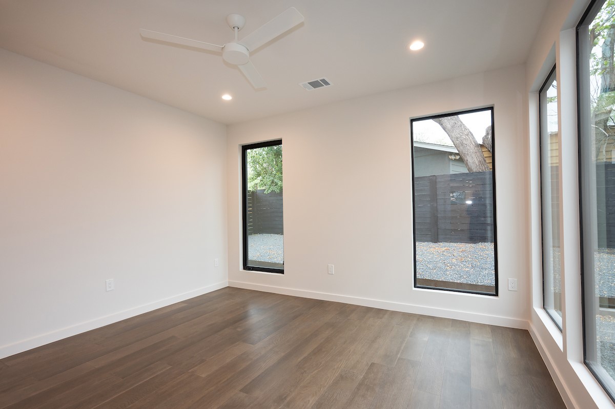 4906 Aberdeen Circle Austin, TX 78745 - Photo 14 of 28 an empty room with wooden floor and windows