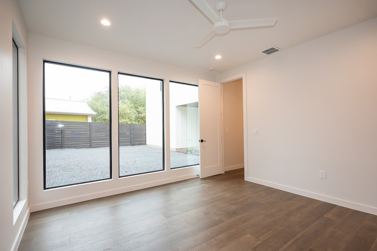 4906 Aberdeen Circle Austin, TX 78745 - Photo 15 of 28 an empty room with wooden floor and windows