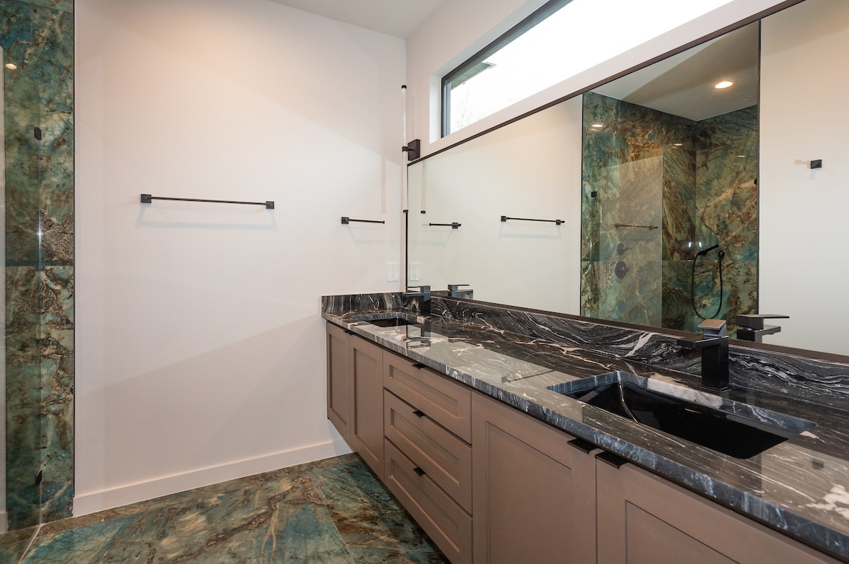 4906 Aberdeen Circle Austin, TX 78745 - Photo 16 of 28 a bathroom with a granite countertop sink and a mirror