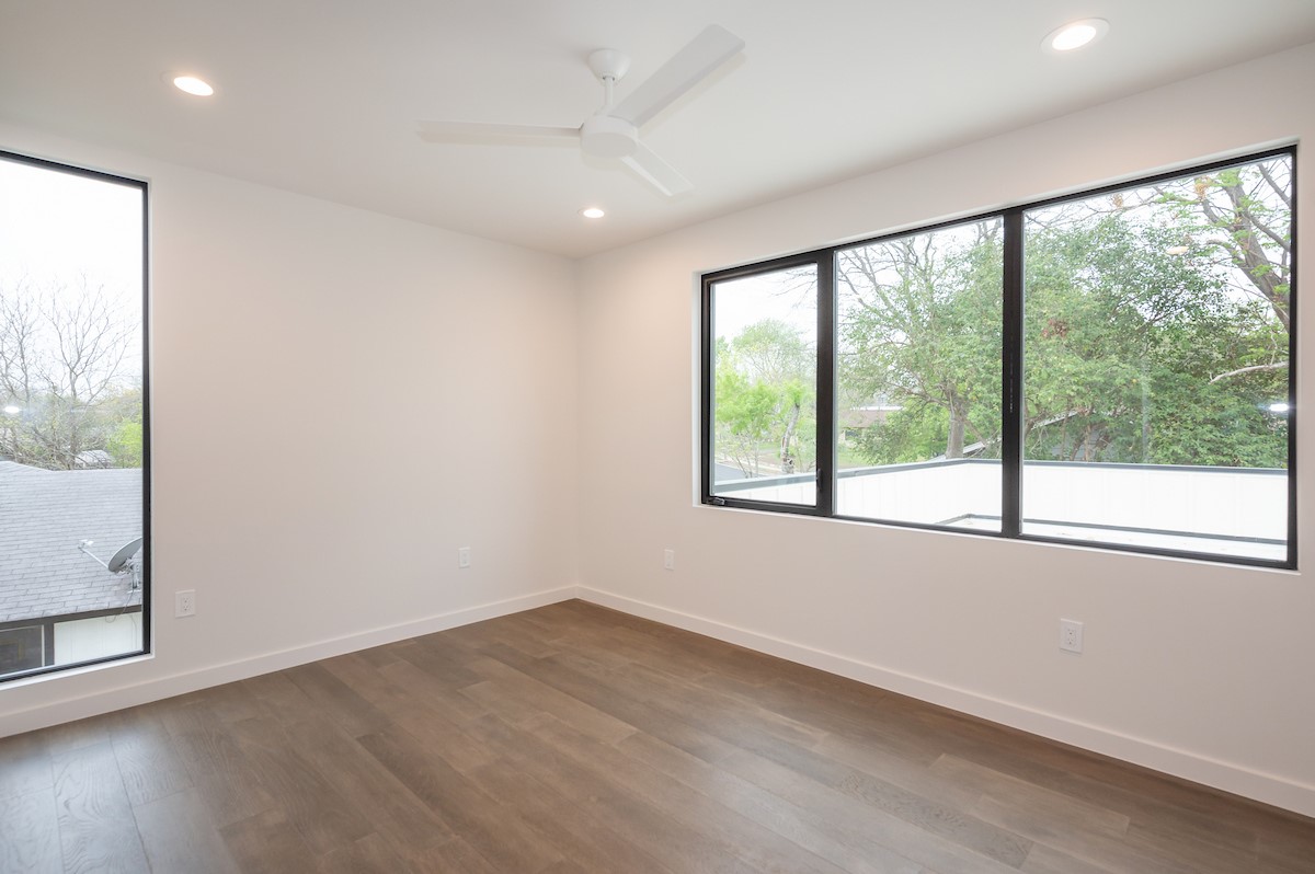 4906 Aberdeen Circle Austin, TX 78745 - Photo 20 of 28 an empty room with wooden floor and windows