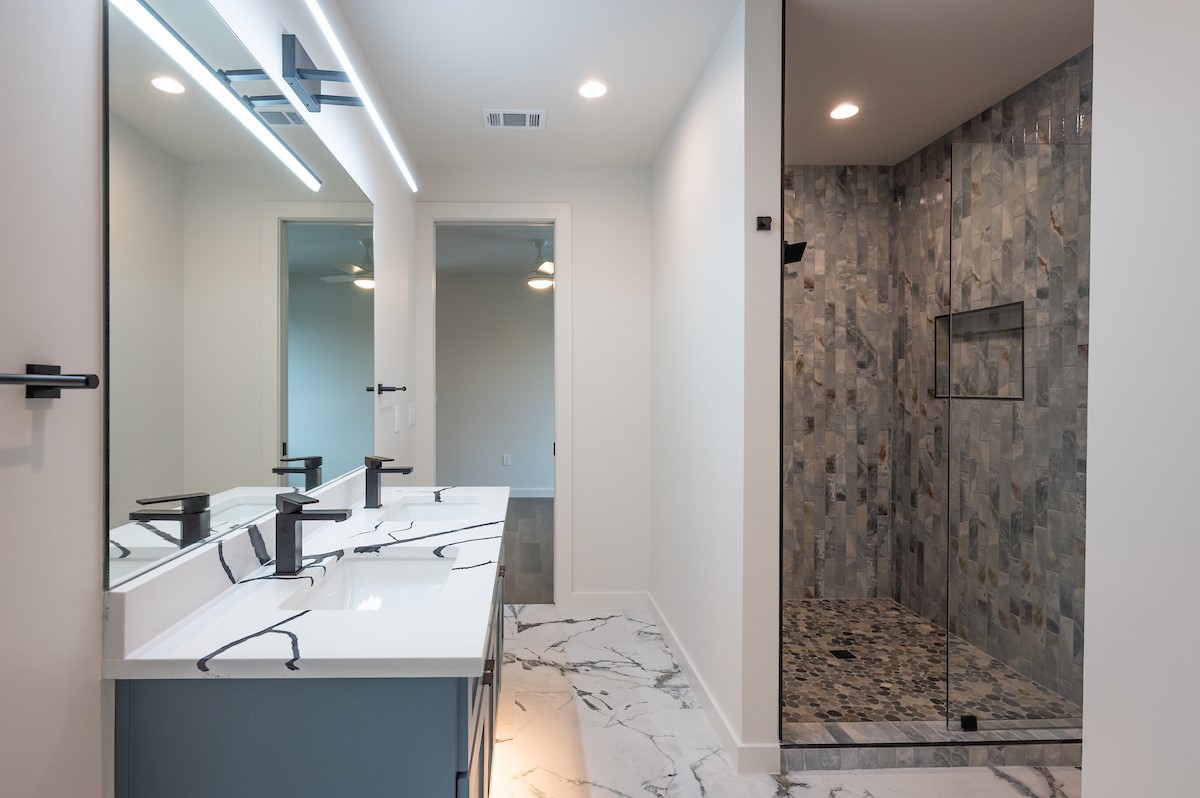 4906 Aberdeen Circle Austin, TX 78745 - Photo 25 of 28 a bathroom with a sink shower and a mirror