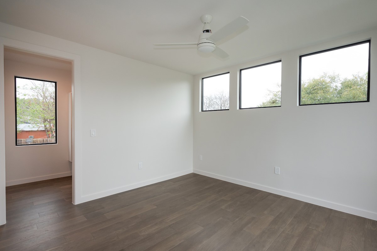 4906 Aberdeen Circle Austin, TX 78745 - Photo 26 of 28 an empty room with wooden floor and windows