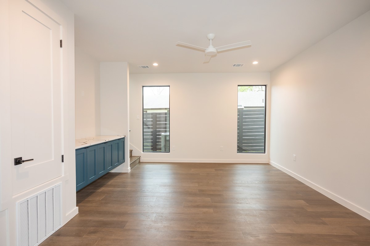 4906 Aberdeen Circle Austin, TX 78745 - Photo 6 of 28 a view of an empty room with wooden floor and a window