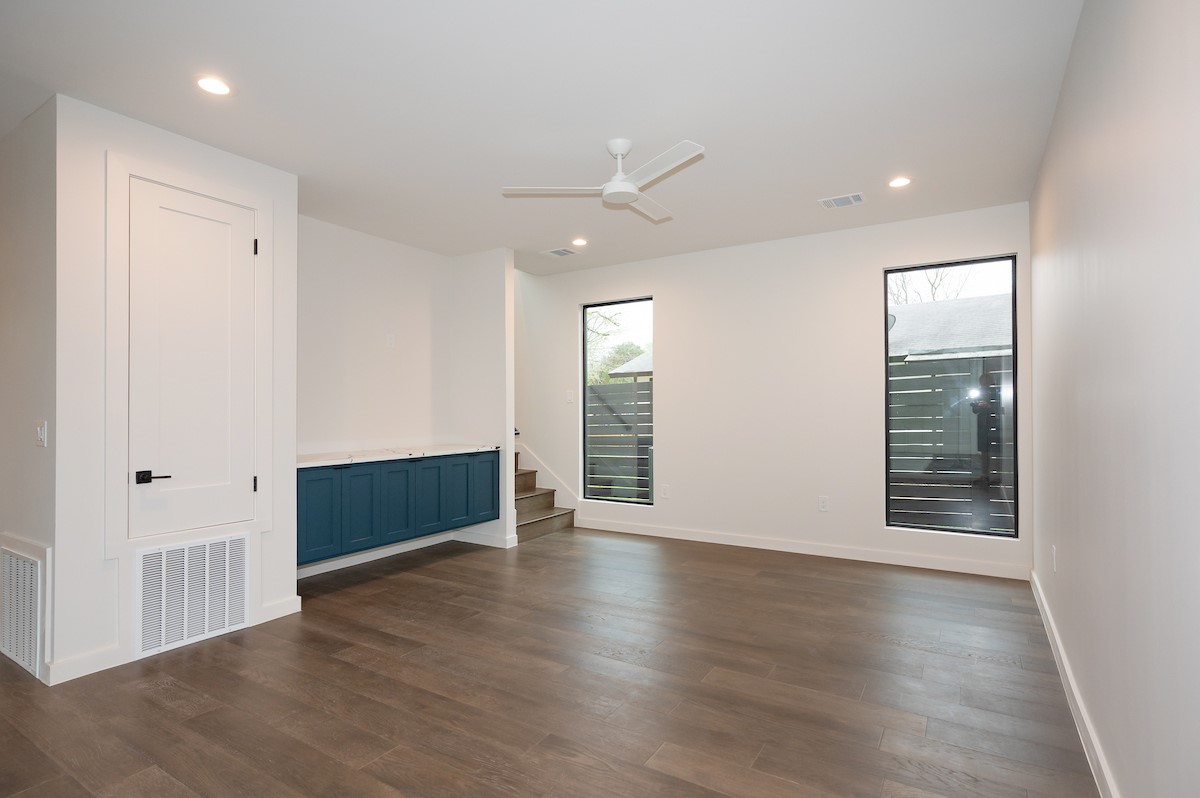 4906 Aberdeen Circle Austin, TX 78745 - Photo 7 of 28 an empty room with wooden floor and windows