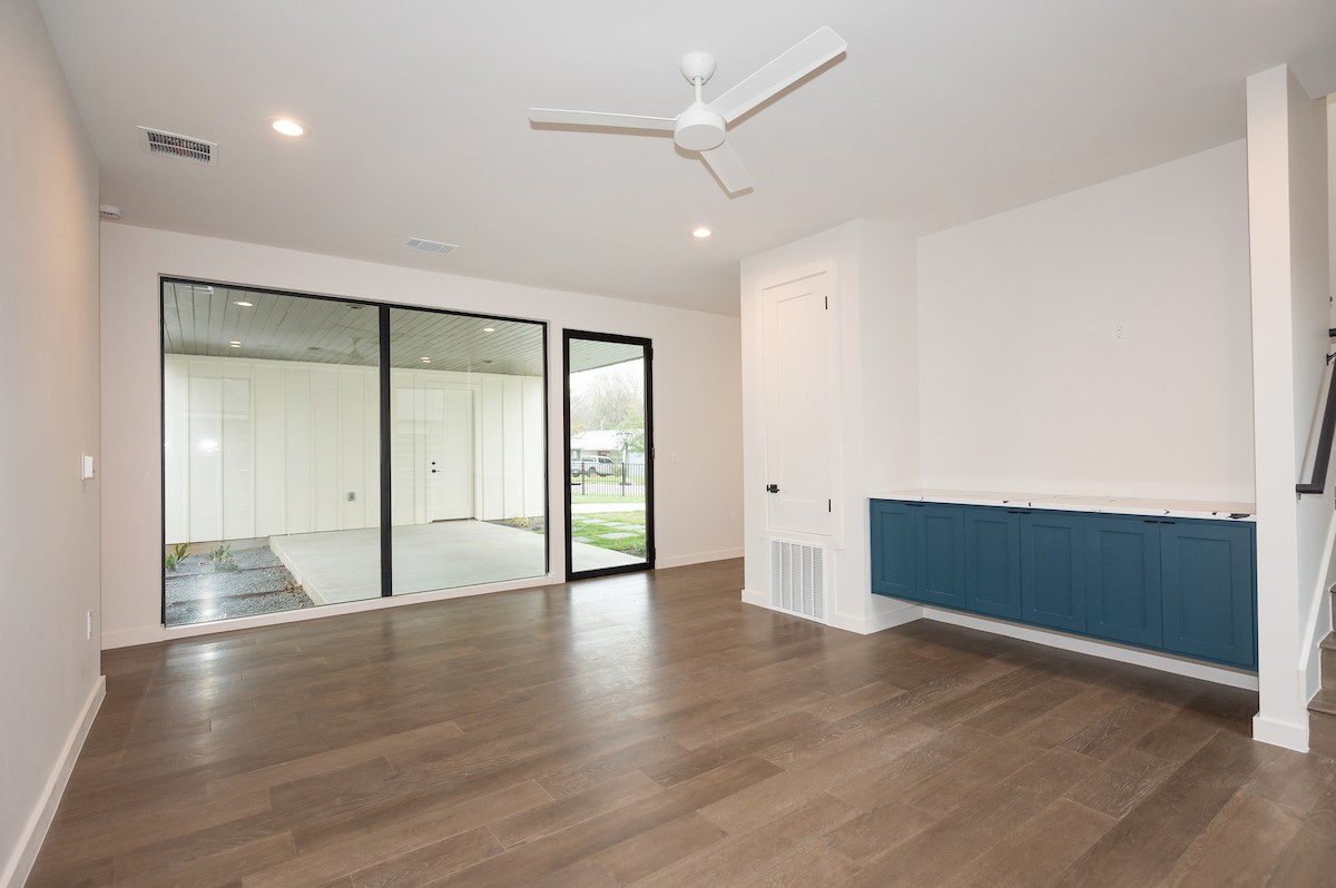 4906 Aberdeen Circle Austin, TX 78745 - Photo 8 of 28 an empty room with wooden floor and windows