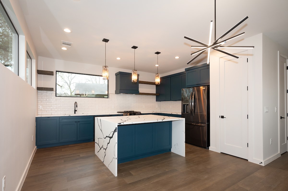 4906 Aberdeen Circle Austin, TX 78745 - Photo 10 of 28 a kitchen with stainless steel appliances granite countertop a sink and a refrigerator