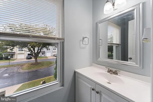 a bathroom with a sink and a window