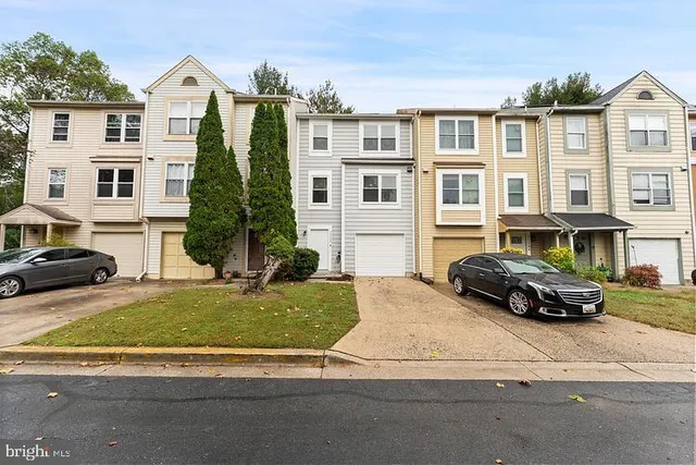 a car parked in front of a white house