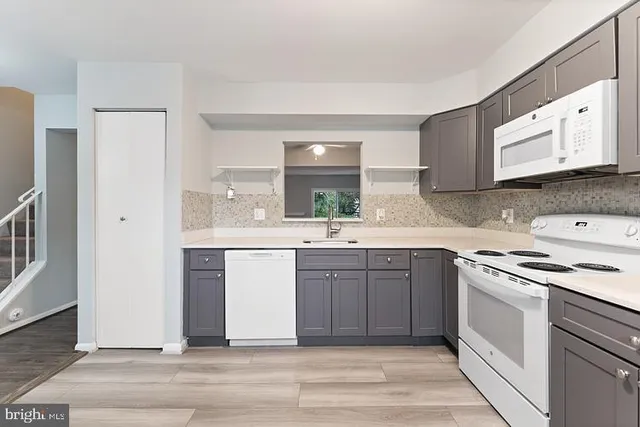 a kitchen with a sink stove and cabinets