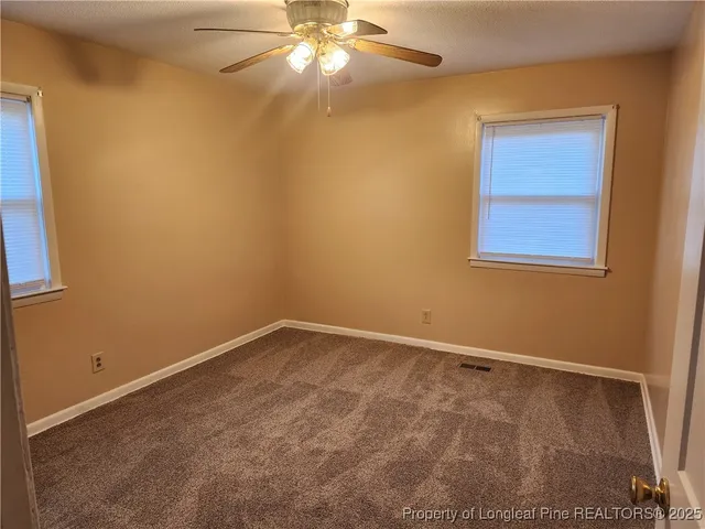 an empty room with a window and closet