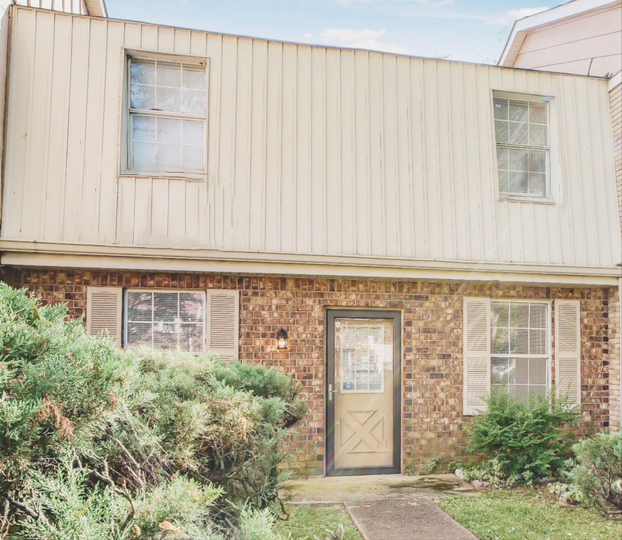 a front view of a building with garden