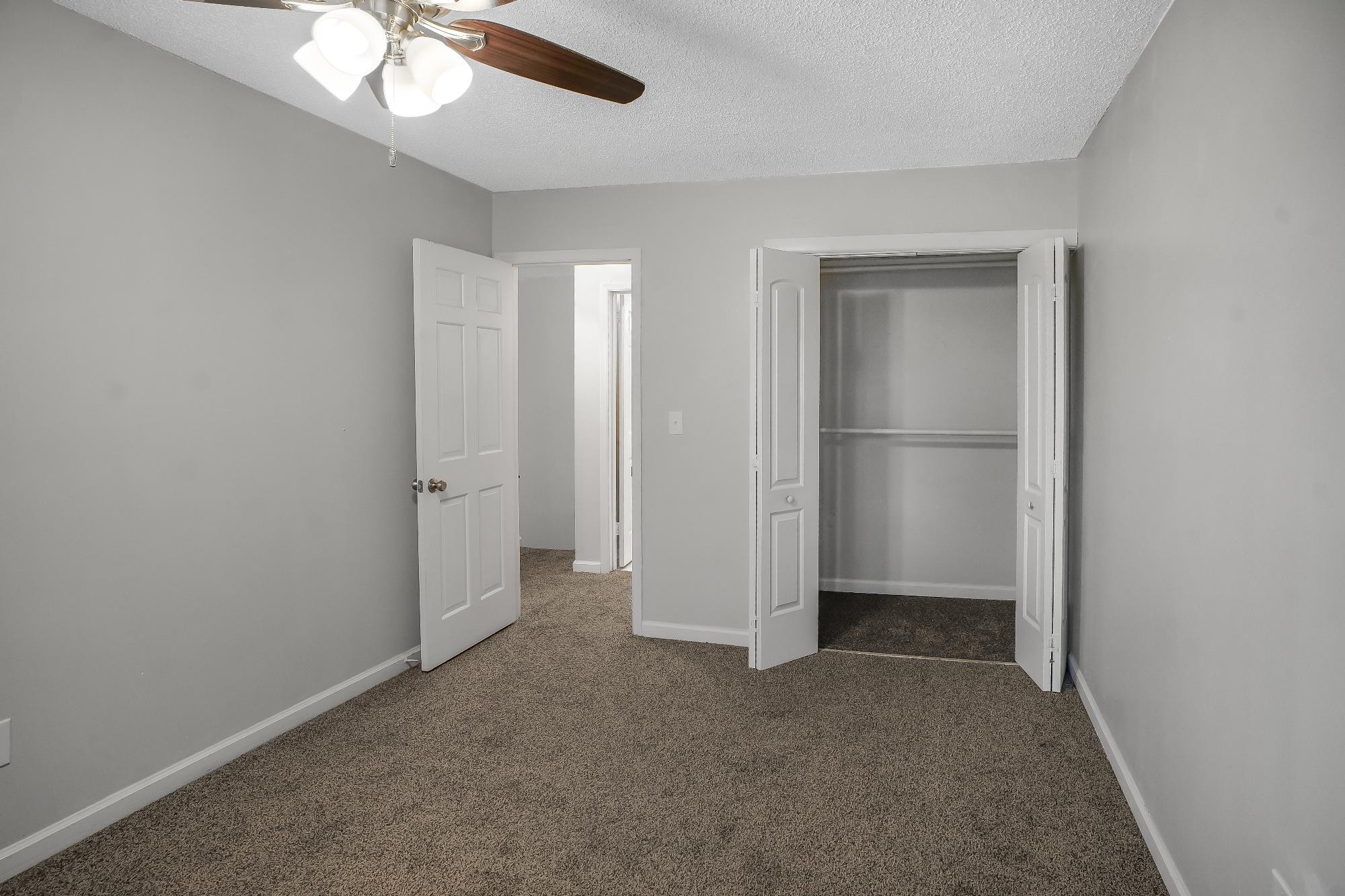 1301 Neelys Bend Road, Unit 73 Madison, TN 37115 - Photo 14 of 17 an empty room with closet and a chandelier fan