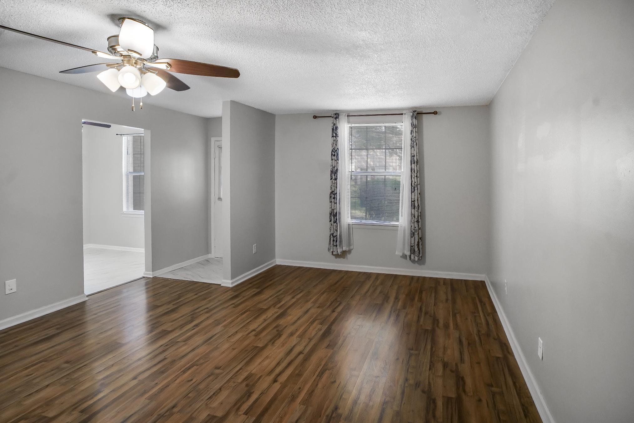 1301 Neelys Bend Road, Unit 73 Madison, TN 37115 - Photo 5 of 17 a view of an empty room with wooden floor and a window