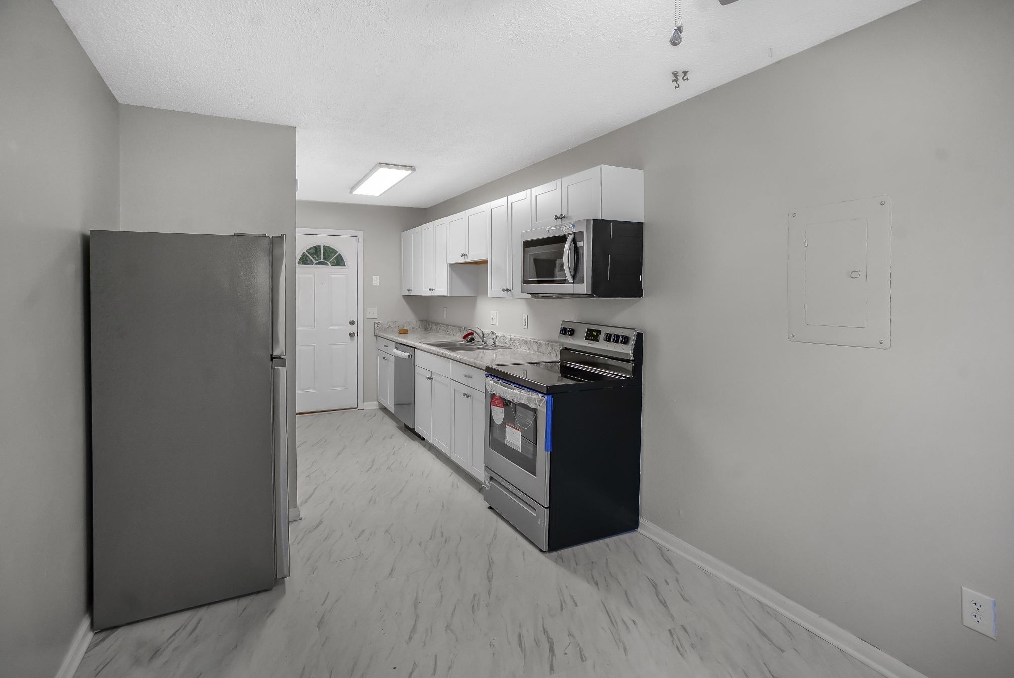 1301 Neelys Bend Road, Unit 73 Madison, TN 37115 - Photo 8 of 17 a kitchen with stainless steel appliances a refrigerator a stove a microwave a sink and cabinets