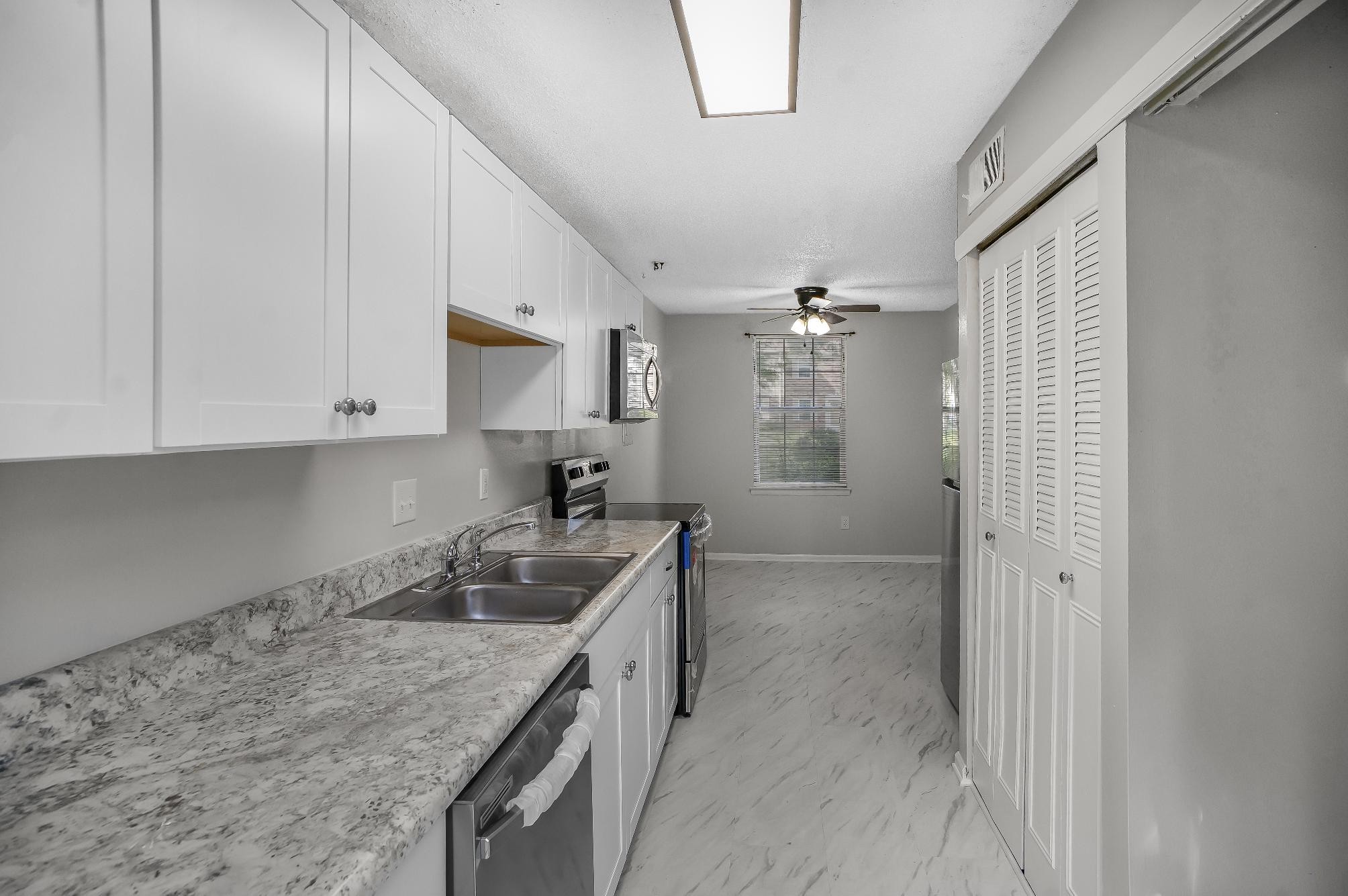 1301 Neelys Bend Road, Unit 73 Madison, TN 37115 - Photo 9 of 17 a kitchen with granite countertop a sink and cabinets