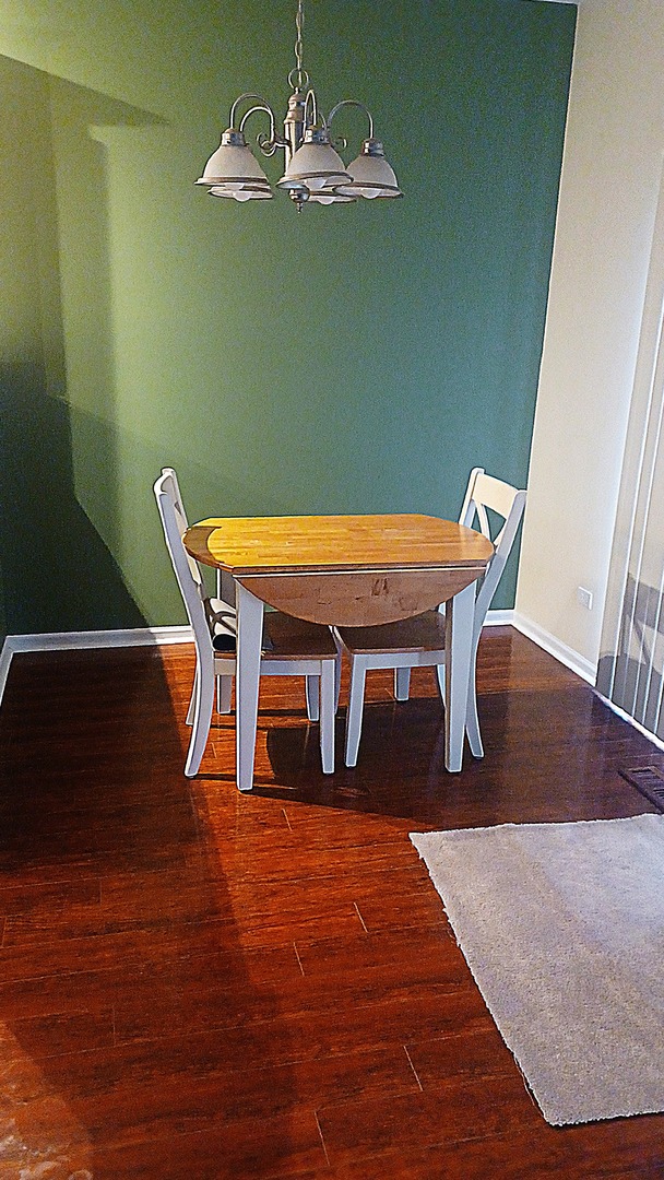 17543 Gilbert Drive Lockport, IL 60441 - Photo 11 of 54 a dining room with furniture a chandelier and wooden floor