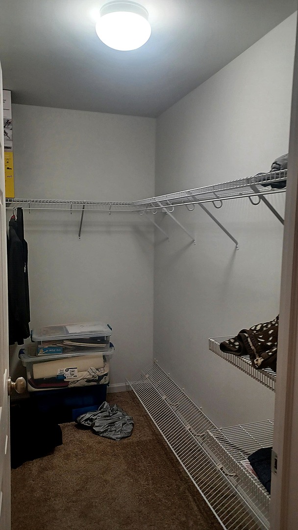 17543 Gilbert Drive Lockport, IL 60441 - Photo 36 of 54 a room with water heater and wooden cabinets