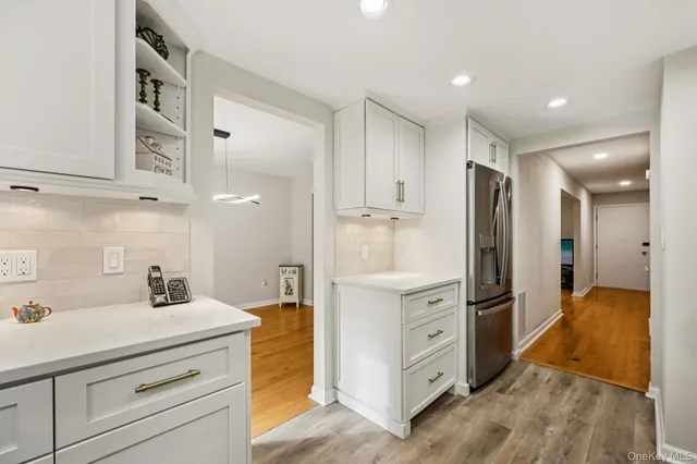 a kitchen with a refrigerator and a sink