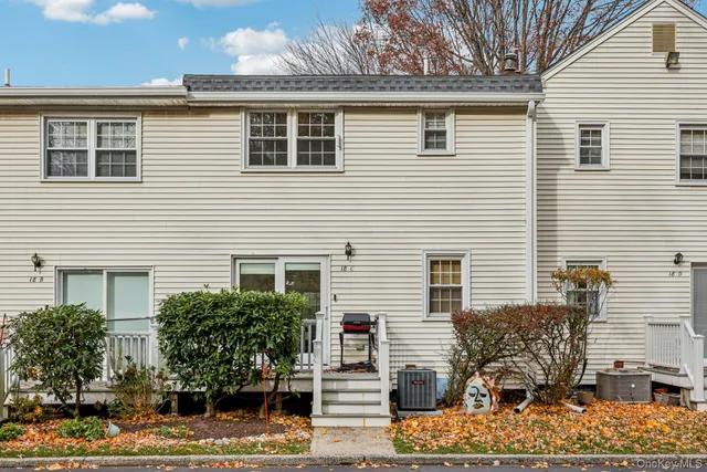 a front view of a house with plants