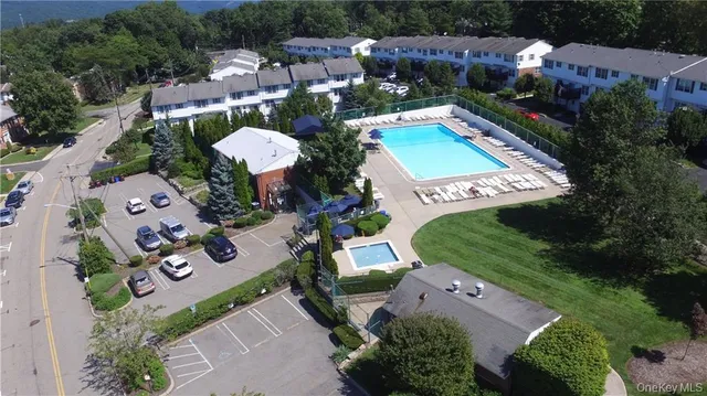 an aerial view of a house with a swimming pool outdoor seating and yard